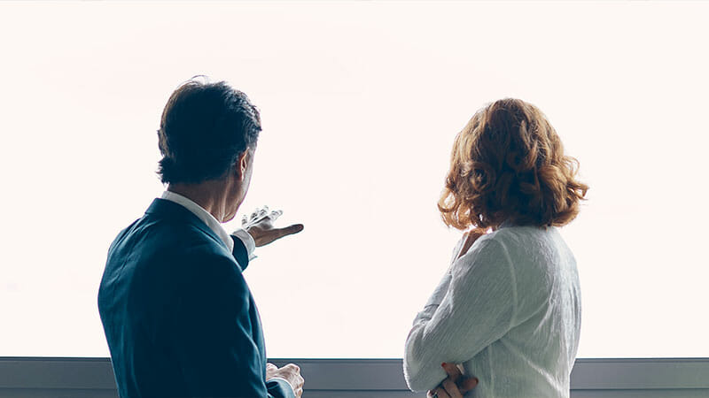 A business man talking to woman and showing around the airport